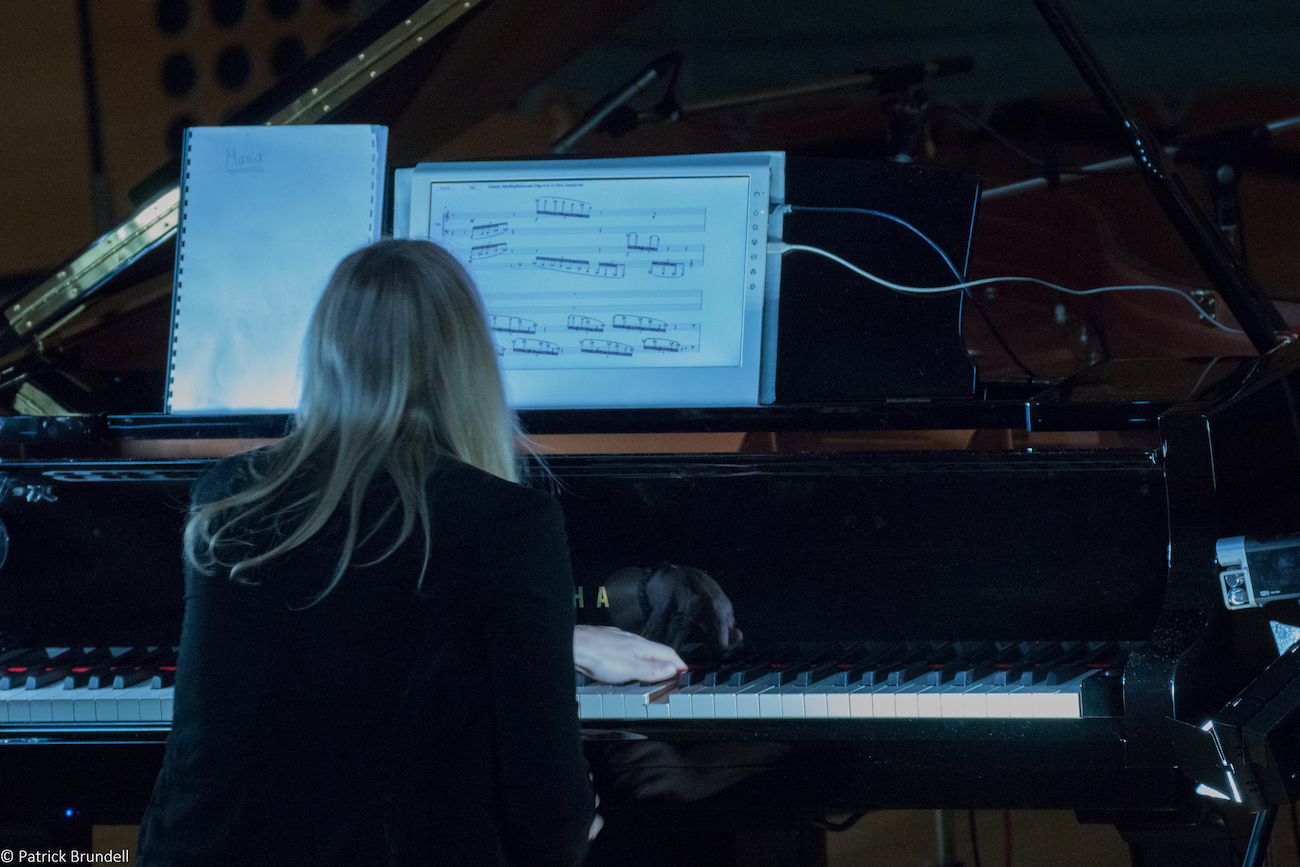 Maria reading a screen-based score during performance